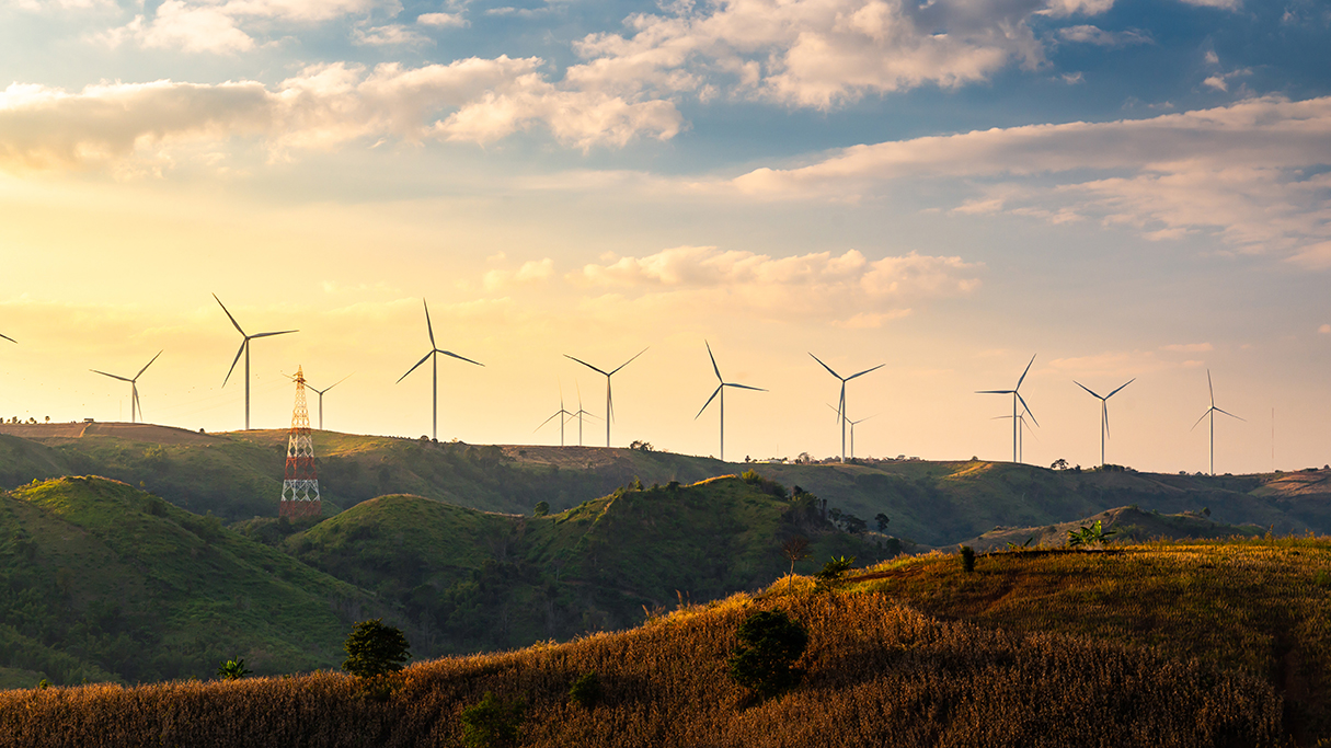 Wind turbines and Orange sunset sky. Beautiful mountain landscape with wind generators turbines,Thailand. Renewable energy concept.