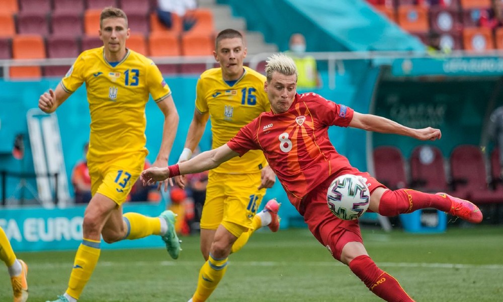 North Macedonia's Ezgjan Alioski shoots and scores his side first goal during the Euro 2020 soccer championship group C match between Ukraine and North Macedonia at the National Arena stadium in Bucharest, Romania, Thursday, June 17, 2021. (AP Photo/V