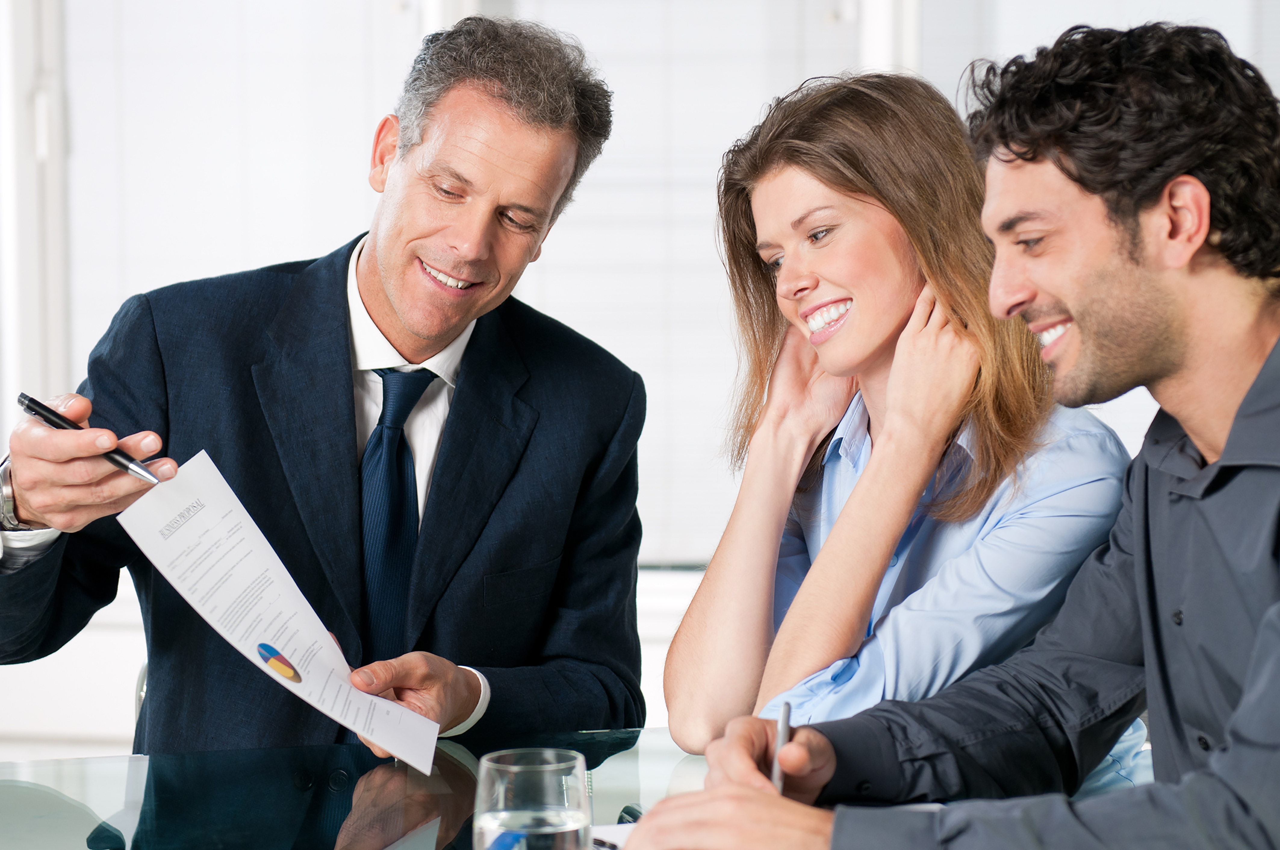 Happy young couple discussing with a financial agent their new investment