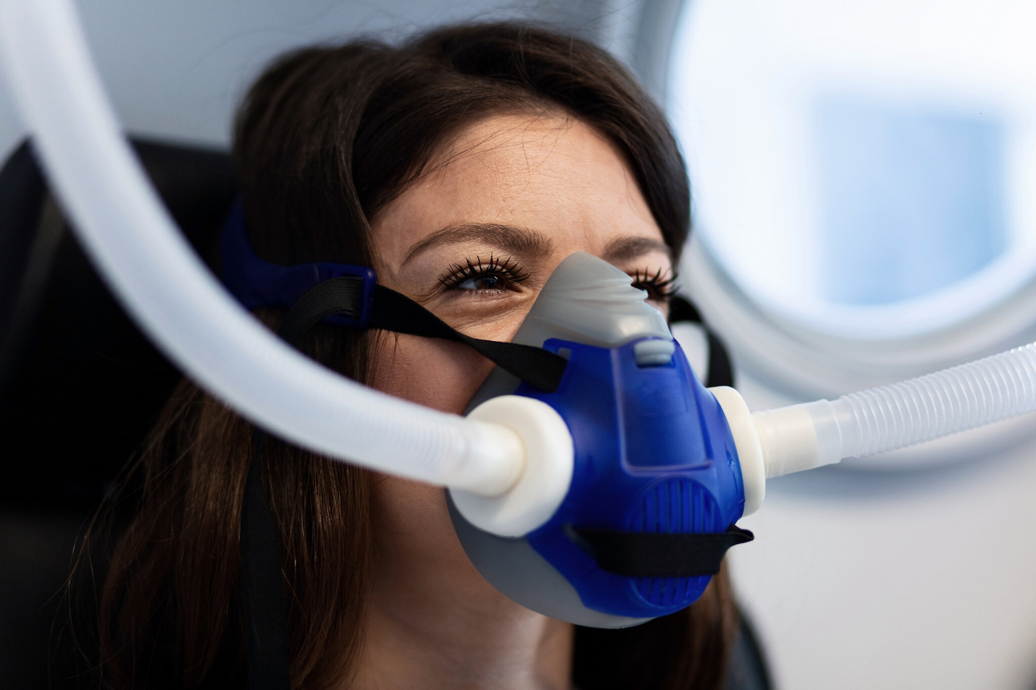 Female patient wearing mask while having hyperbaric oxygen therapy.